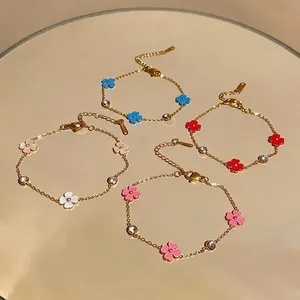 Pulseras de acero inoxidable dorado con flores de esmalte de colores y circonitas.