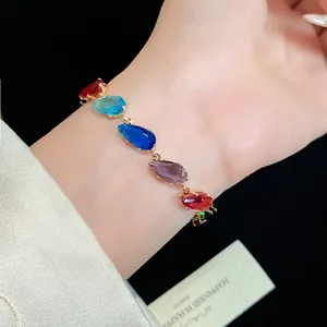 Detail shot of colorful dopamine teardrop zircon bracelet on wrist with luxury gold finish