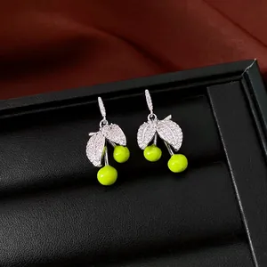 Sparkling silver cherry earrings with vibrant green globes and cubic zirconia leaves.