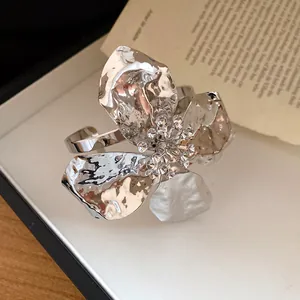 Detail shot of a silver metallic wrinkled flower double-layer open cuff bracelet.