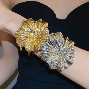 Detailed macro view of elegant metallic wrinkled flower bracelets in gold and silver