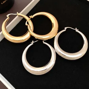 Elegant chunky metallic glossy hoop earrings with a hollow design in gold and silver tones
