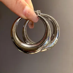 High-shine polished silver metallic chunky hoop earrings with a smooth mirror finish.