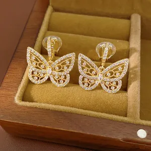 Close-up of gold butterfly clip-on earrings with shimmering cubic zirconia in a box
