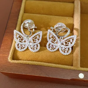 Close-up view of elegant silver butterfly clip-on earrings with sparkling cubic zirconia