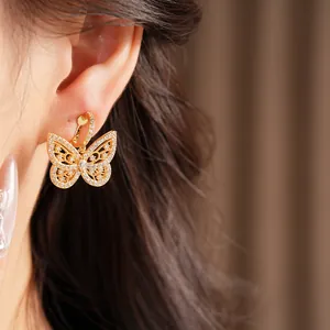 Detailed view of 18K gold plated butterfly ear clip with sparkling cubic zirconia
