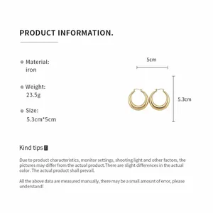 Detailed view of large golden hollow hoop earrings with dimensions and material info