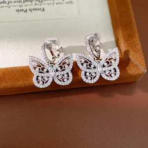 Detail view of silver-toned butterfly clip earrings encrusted with sparkling zircons