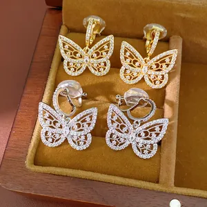 Detailed view of 18K gold plated butterfly ear clips adorned with sparkling zircons.
