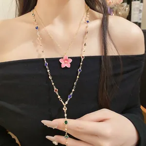 Double-layered vintage necklace featuring a pink flower pendant and colorful crystal beads