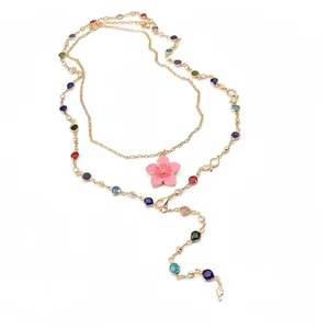 Vintage gold lariat necklace featuring colorful crystal beads and a pink enamel flower pendant