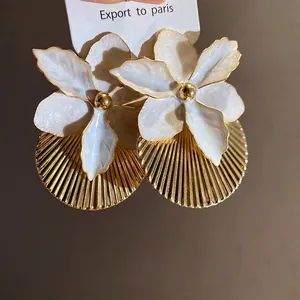 Elegant vacation style white enamel flower earrings with pleated gold circular disks