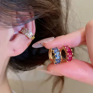 Close-up of 18k gold plated square zircon ear cuffs in white, blue and red colors