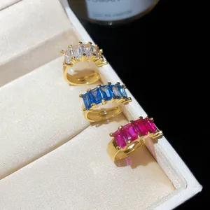 Detail view of 18k gold plated ear cuffs with colorful rectangular cubic zirconia.