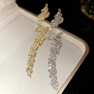Close-up view of elegant gold and silver leaf wrap rings encrusted with marquise zircons