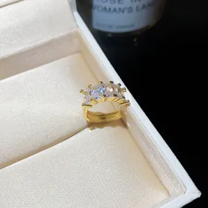 Macro detail of 18k gold plated ring featuring five radiant emerald cut zircon stones