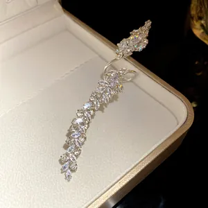 Close-up detail of a sparkling marquise zircon leaf open ring in a cream jewelry box