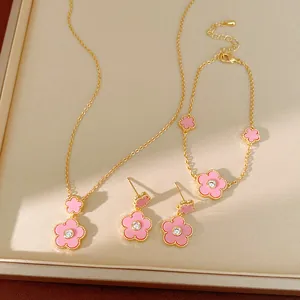 Detailansicht eines vergoldeten Schmucksets mit rosa Blumen, Halskette und Armband