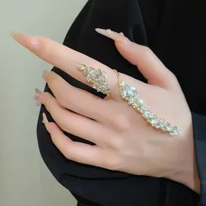 Close-up detail of adjustable gold leaf ring with sparkling marquise zircons worn on hand