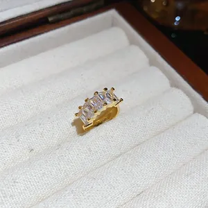 Close-up of 18k gold plated ear cuff with four baguette-cut zirconia stones