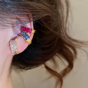 Close-up of 18k gold plated rectangular cubic zirconia ear cuffs in three colors