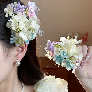 Detailed macro view showing the texture of fabric flower hair clip with white lace bow