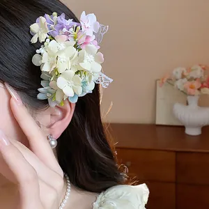 Elegant detail of a sweet floral hair clip featuring delicate lace accents on a model.