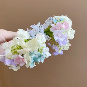 Close-up of elegant handmade lace bow hair clip with colorful pastel fabric flowers