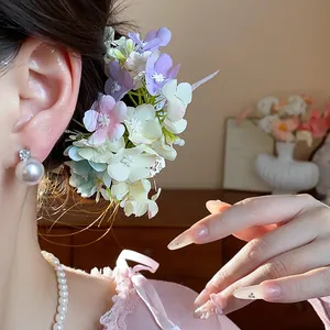 Close-up of elegant floral fabric hair clip with lace details on an Asian model