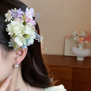 Detail view of a sweet fabric flower hair clip with an elegant lace bow on hair.