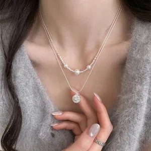Detail shot of elegant double-layered necklace with zircon star pendant and pearls