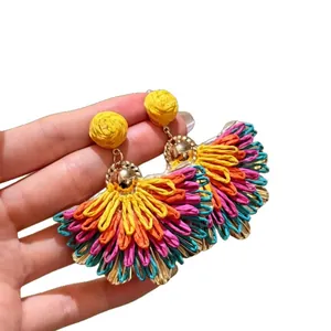 Colorful raffia fan-shaped earrings with woven design for a tropical vacation vibe.