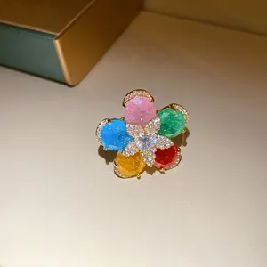 Detailed macro view of an 18k gold plated flower ring with vibrant colorful zircon petals