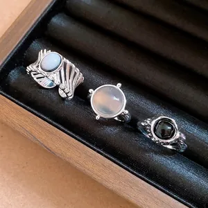 Vintage minimalist hollow open rings with oval and round stones displayed in a jewelry box