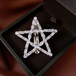 Detailed macro view of clear zircon crystals set in a star-shaped silver hair clip
