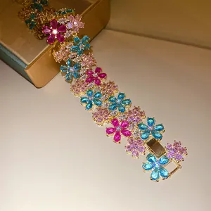 Macro shot of a luxurious 18k gold-plated zircon flower bracelet with colorful stones