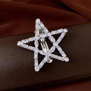 Exquisite close-up of a vintage star-shaped hair clip with sparkling white zircons