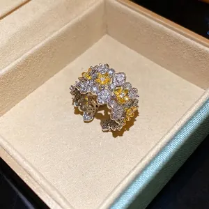 Vintage floral zircon open ring with yellow and white stones in a jewelry box