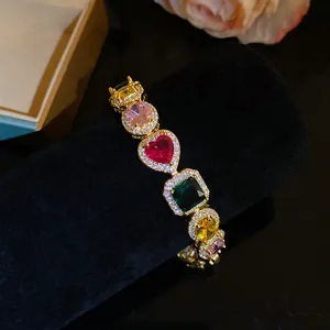 Detailed view of colorful heart and square zirconia stones on 18k gold bracelet