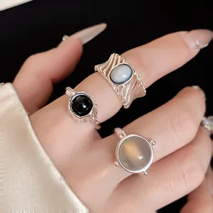 Detailed macro view of vintage silver hollow rings featuring unique oval gemstone accents