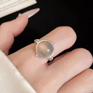 Macro detail of a vintage silver open ring with a large translucent round grey gemstone