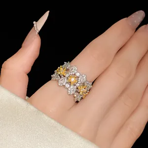 Close-up macro shot of a sparkling zircon flower ring worn on a finger for jewelry detail