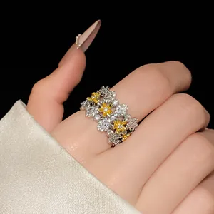 Close-up detail of a sparkling cubic zirconia flower open ring worn on a model's finger