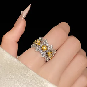 Detailed view of a sparkling zircon flower ring on a finger, elegant vintage style.