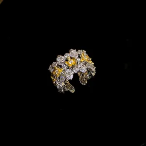 Close-up detail of a vintage style zircon flower open ring with gold and silver accents