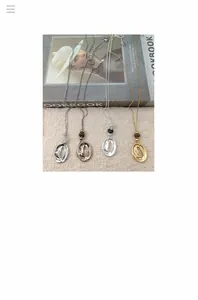 Detailed view of minimalist stainless steel irregular oval pendant necklaces in various finishes