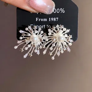 Elegant fireworks stud earrings with pearls and sparkling cubic zirconia stones