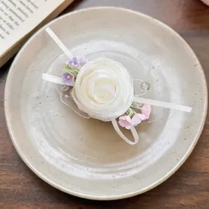 Close-up of elegant white chiffon flower hair clip with pink and purple blossoms