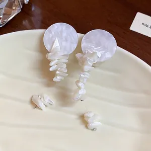 Elegantes pendientes de plata con tachuelas redondas y colgantes de concha blanca