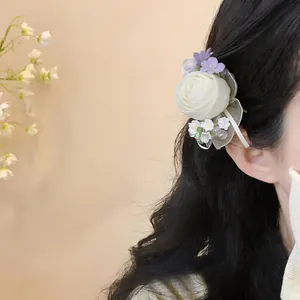 Detailed view of a delicate Mori-style chiffon rose hair clip with elegant pearl accents